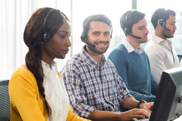 Team working on computer with headset