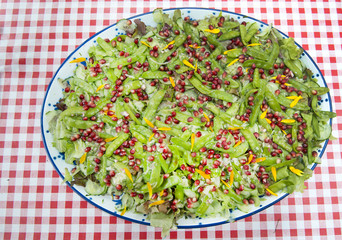 garden salad with pommgranate seed in a summer garden