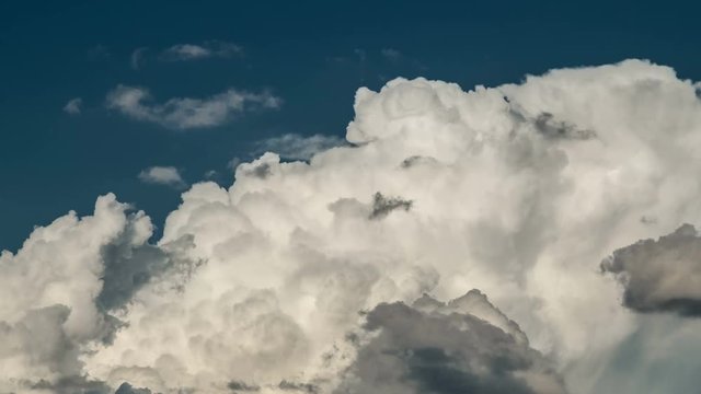 4K Timelapse of white, fluffy, bubbling cumulous storm clouds