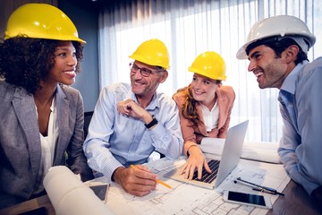 Smiling architects interacting with each other