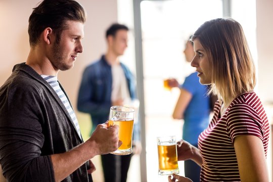 Young couple with beer mug in bar