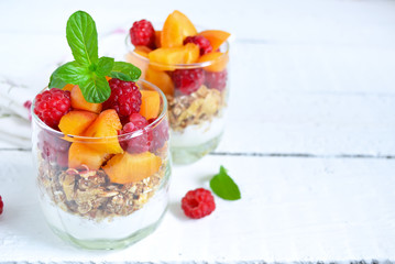 Homemade yogurt with granola apricots, peaches and raspberries o
