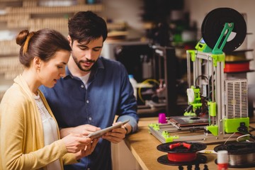 Graphic designers interacting using digital tablet