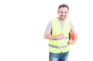 Fototapeta premium Cheerful male constructor holding his protection helmet