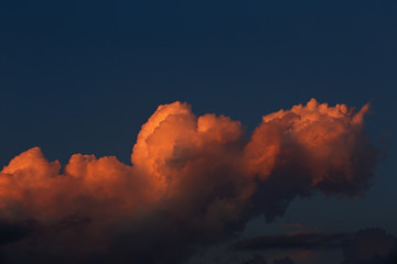 Clouds in the evening sky illuminated by the sun has sat down fo