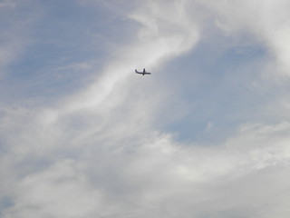 Airplane in the cloudy sky