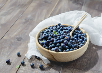 Fototapeta na wymiar Cup with blueberries and spoon