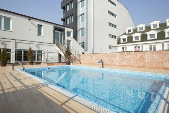 Outdoors swimming pool in front of building