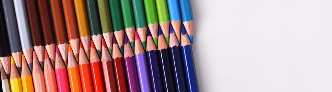 Background colored pencils with tips facing each aligned diagona