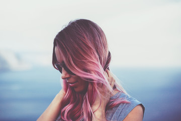 Woman with pink hair over sea