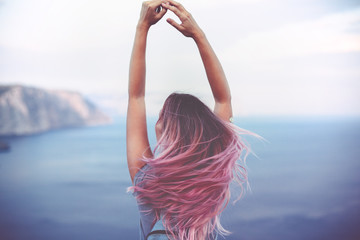 Woman with pink hair over sea