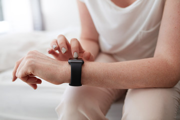 Obraz na płótnie Canvas Woman using smartwatch to check time