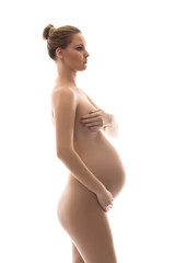 Fototapeta premium Naked pregnant woman with a beautiful belly