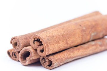 Cinnamon sticks over white with copy space