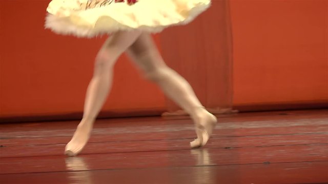 Ballerina feet in pointe shoes at dance.