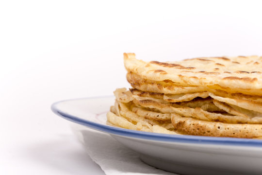 Homemade pancakes on the plate. Isolated on white background.