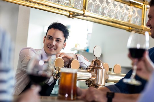 Bartender Talking With Customers Counter