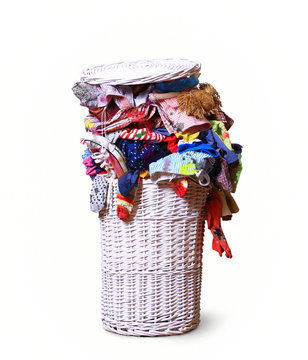 White straw basket full of dirty Laundry