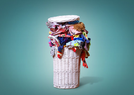 White straw basket full of dirty Laundry