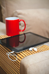Coffee and plate on the arm of the sofa