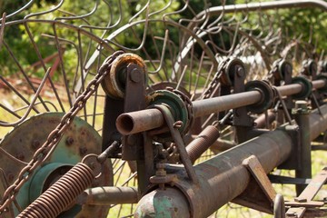 Old rusty Hay Turner.  Old agricultural equipment on hay.
