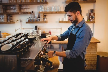 Man taking coffee from espresso machine