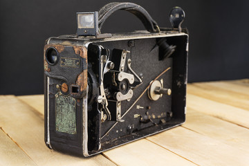Very old handheld video camera on wooden desk