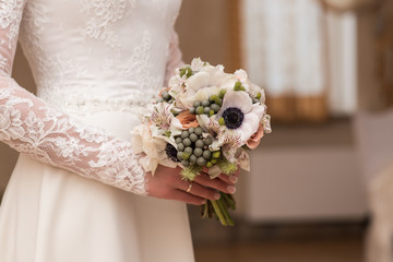 beautiful wedding bouquet in hands of the bride