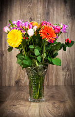 Mixed beautiful flowers on wooden background