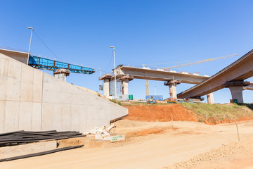 Construction Highway intersection junction flyover ramps structures for traffic flow.