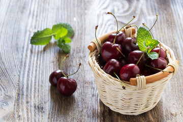Fototapeta na wymiar Sweet cherries in small basket