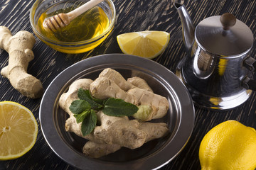Teapot of ginger tea with honey and lemon.