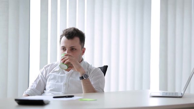 Young man drink in the office