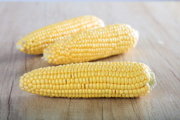 corns on a wooden surface