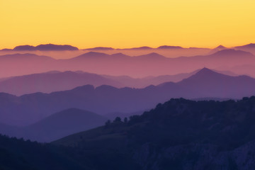Fototapeta na wymiar pattern of distant mountain layers at sunset
