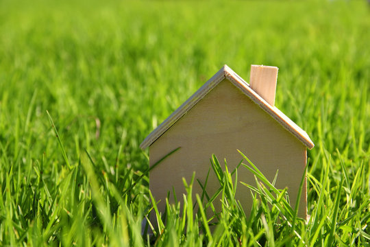  Image of vintage wooden toy house in the grass