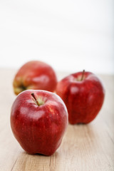 apples on a wooden surface