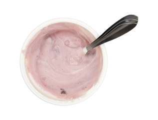 Container of stirred black cherry Greek yogurt with spoon isolated on a white background top view.