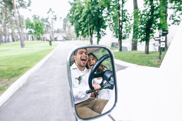 Bride and groom driving a golf cart