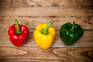 Colorful peppers on rustic wooden table