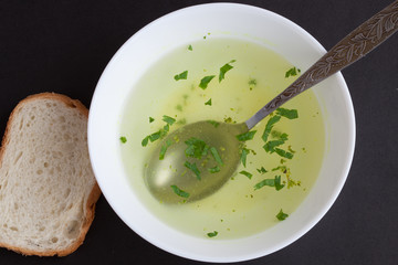 Clear soup in a white cup
