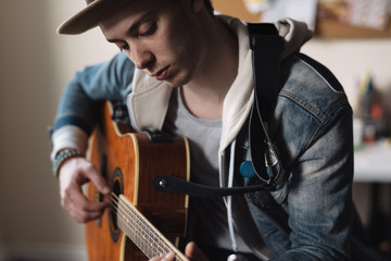 Young man playing acoustic guitar