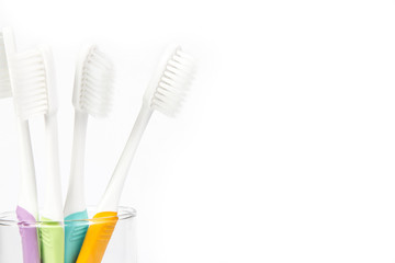 close up toothbrush in transparent glass on white background