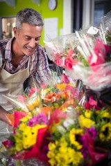 Male florist arranging bouquet of flower
