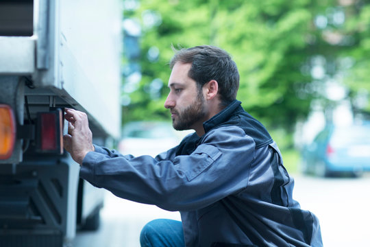 Man adjusting truck control panel