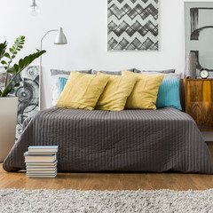 Bed with decorative yellow pillows