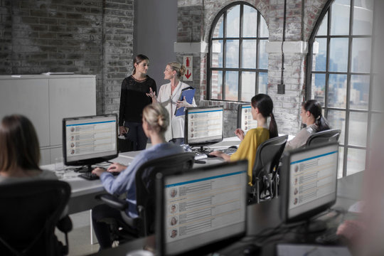 Female workers at training presentation in call centre