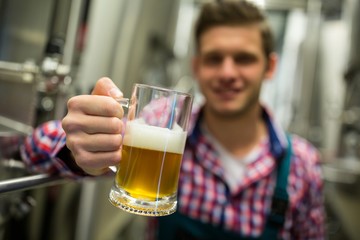 Brewer holding a glass of pint beer