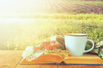 Fashion scarf with cup of coffee and old book