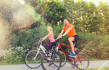 Plakat happy couple riding bicycle outdoors